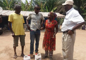 The Commercial Director of New Okaff Industries Limited, Mr. Kwasi Boamah with some farmers affected