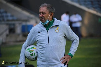 Coach Milovan (right) arrives at GFA HQ with his interpreter