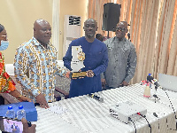 Public Enterprises Minister Joseph Cudjoe (left) showcasing PELT plaque