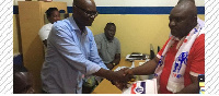 Kenneth Agyei Kuranchie (right) hands over forms to a party executive