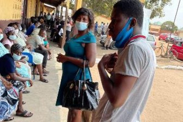 People throng a local school in Tema to receive their shots