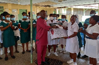 MCE Daniel Noble Awume handing over a citation to a staff member