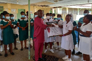 MCE Daniel Noble Awume handing over a citation to a staff member