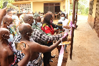 Shirley Tony Kum cutting the tape to commission the renovated school block