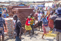 Traders jubilate over the items that were distributed to them by Valentino Nii Noi Nortey