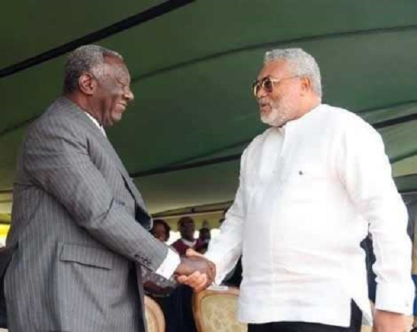 Former President Rawlings in a handshake with Former President Kufuor