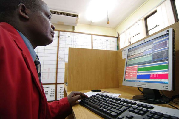 A trader looks at his screen in the trading room of the Dar es Salaam Stock Exchange in Tanzania