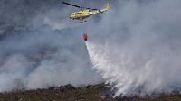 Strong winds have spread the fire and complicated response efforts