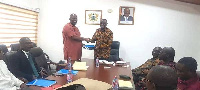 Prof.Adjei Kumi left presenting the report to Mr Dan Botwe