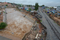 The Odaw river flowing through Abofu eroding part of railway and concrete slabs within the drainage