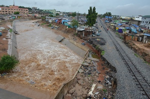 The Odaw river flowing through Abofu eroding part of railway and concrete slabs within the drainage