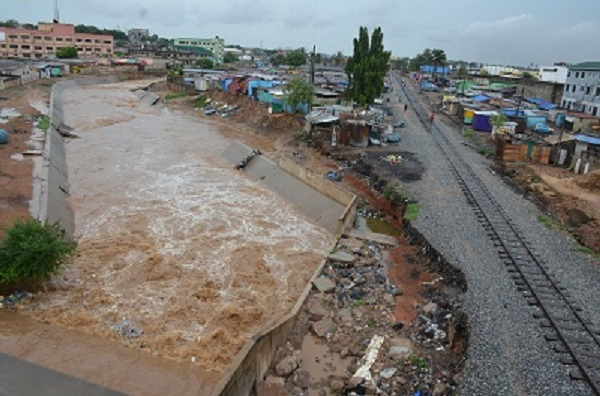 The Odaw river flowing through Abofu eroding part of railway and concrete slabs within the drainage