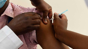 A Kenyan health worker receives a dose of the Oxford/AstraZeneca vaccine at Kenyatta National Hosp