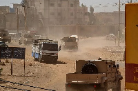 Sudanese army armoured vehicles drive in Khartoum