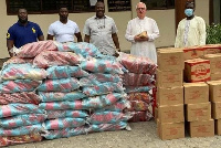 Ibrahim Mahama presenting some relief items to  Christ the King Church