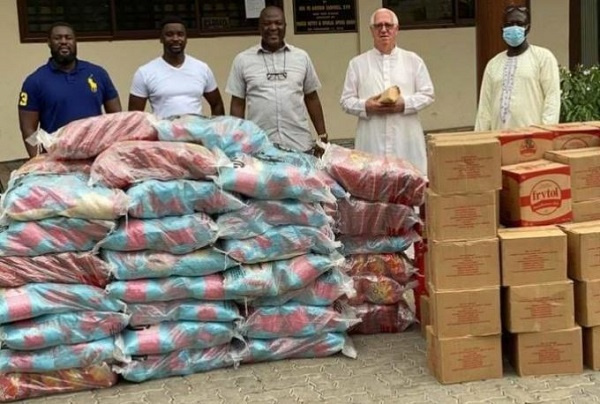 Ibrahim Mahama presenting some relief items to  Christ the King Church