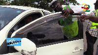 Police and DVLA officials remove the tint from the from windows of a car during compliance checks