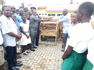 Municipal Chief Executive for Jomoro, Ernest Kofie handing over the items to George Blay Morkeh