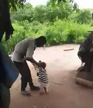 A man flogging a toddler