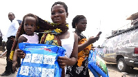 File photo - A mother with a mosquito treated net