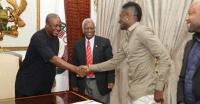 Former President John Dramani Mahama in a handshake with Asamoah Gyan