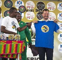 Charles Osei Assibey presenting a shirt to the  Secretary-General of WAF