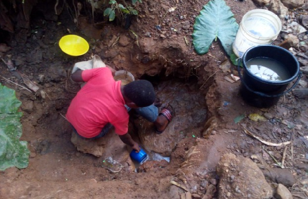 The Kwahu residents scooping water from the ground