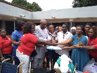 Carlos Ahenkorah presenting some items to Tema Polyclinic