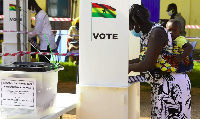 A woman casting her vote at a polling station