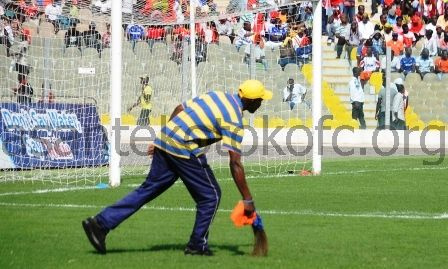 Hearts of Oak official sweeping the field before a league match against rivals Asante Kotoko