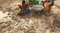 Children in Garizegu getting water from dugouts