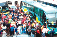 Commuters at a bus terminal in representational photo