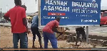 A video showed three men digging up the billboard with pickaxes