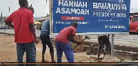 A video showed three men digging up the billboard with pickaxes