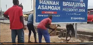 A video showed three men digging up the billboard with pickaxes