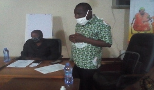 Mr Tampugre (standing) addressing the meeting