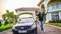 Bayor poses with his one of his luxurious cars