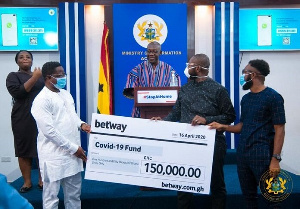 John Peter Amewu, Minister Of Energy receiving the cheque from the Betway reps