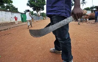 A man holding a cutlass