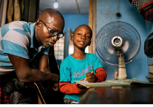 It's their nightly ritual.Herman Agbavor sits with his 5-year-old son, Herbert, over his homework