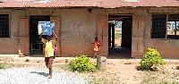 Picture of the school buidling with some pupils