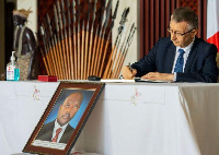 Ambassador of the Federal Republic of Russia to Burundi Valery Mikhaylov signs the condolences book