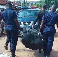 Police carry the bodies of the deceased