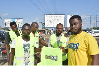 Some of the motor riders receiving their reflector jackets