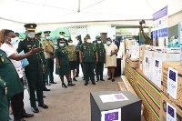 Kofi Wilmot of EU-IOM (L) and Asuah Takyi (2nd L) inspecting the items Photo Samuel Opare Lartey