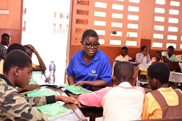 Asiedua Addae interacting with some pupils