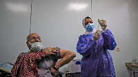 An Egyptian medical worker administers a dose of the Oxford-AstraZeneca Covid-19 vaccine