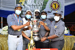 Torgah (left) receiving the trophy from Appiah (second left) and other executives