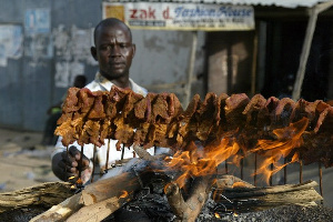 Suya Seller Grilling