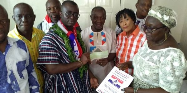 Prince Appiah [in smock] submitting his nomination forms